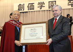 Mr. Likhanov (right) presents Mr. Ikeda with the certificate naming him 